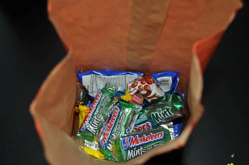 Fill treat bag with candy