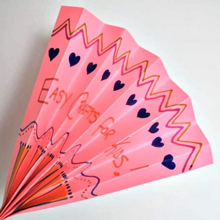 Pink folded paper fan