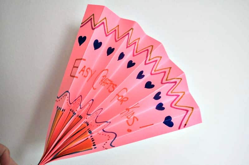 Pink folded paper fan