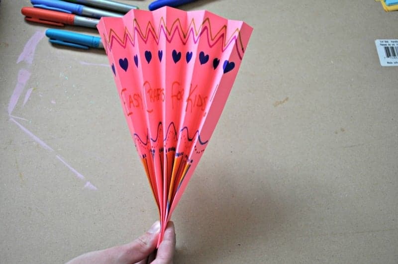 Pinch folded paper on one end to create a fan
