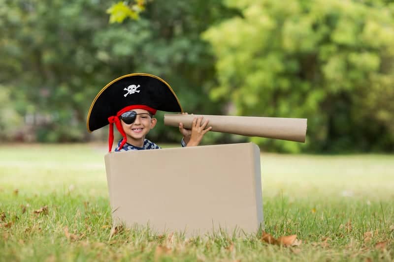 Pirate boy decked out with a pirate hat, pirate eye patch and a pirate telescope