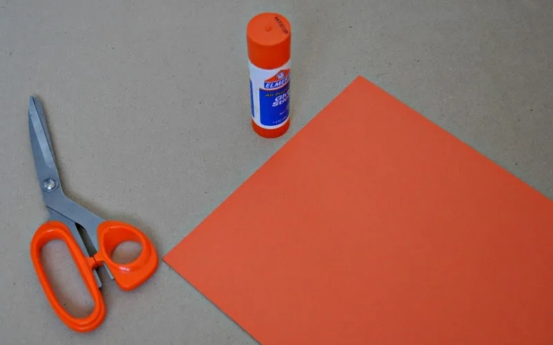 Supplies for making a paper pumpkin for Thanksgiving