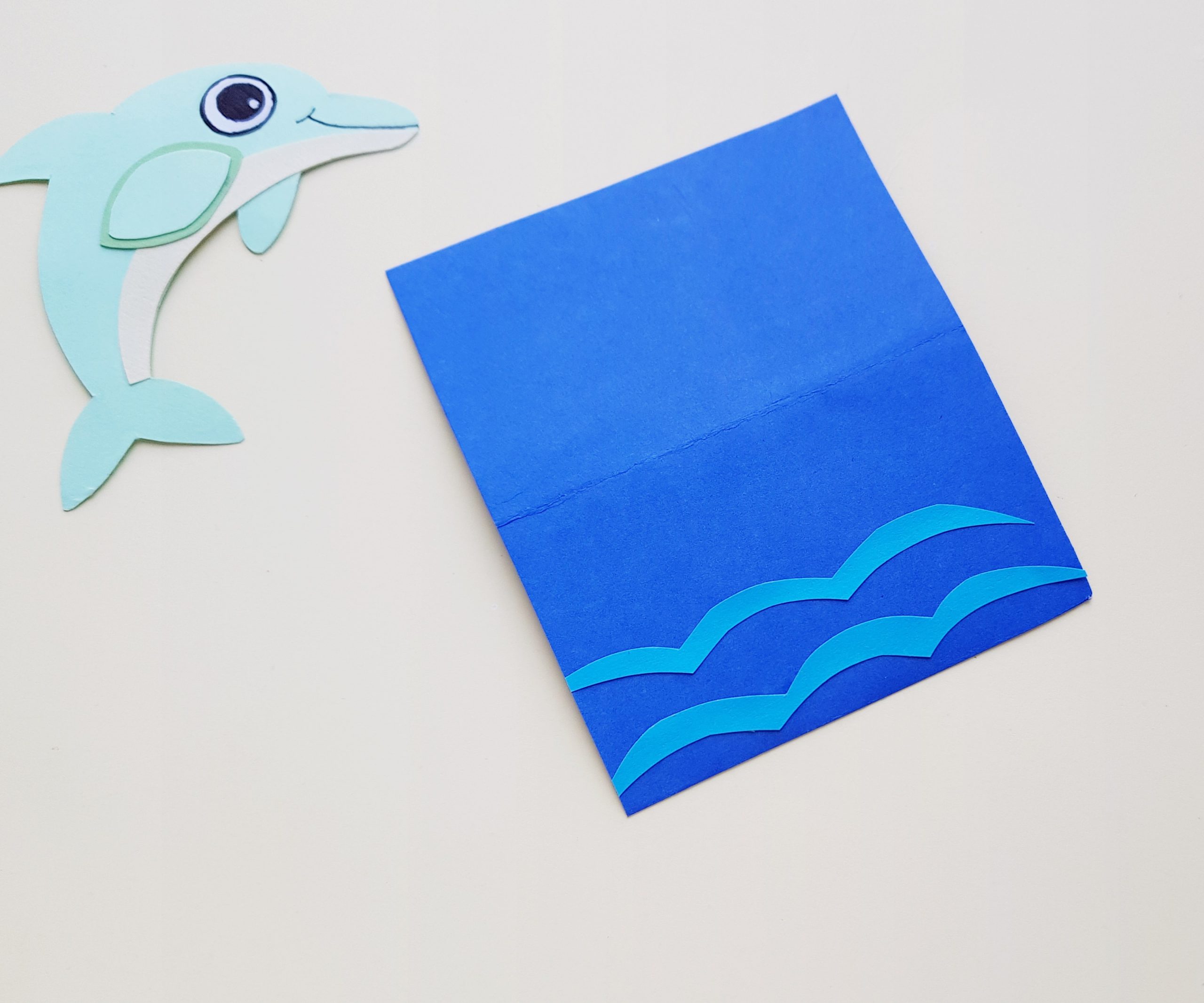 step by step dolphin craft with paper and scissors
