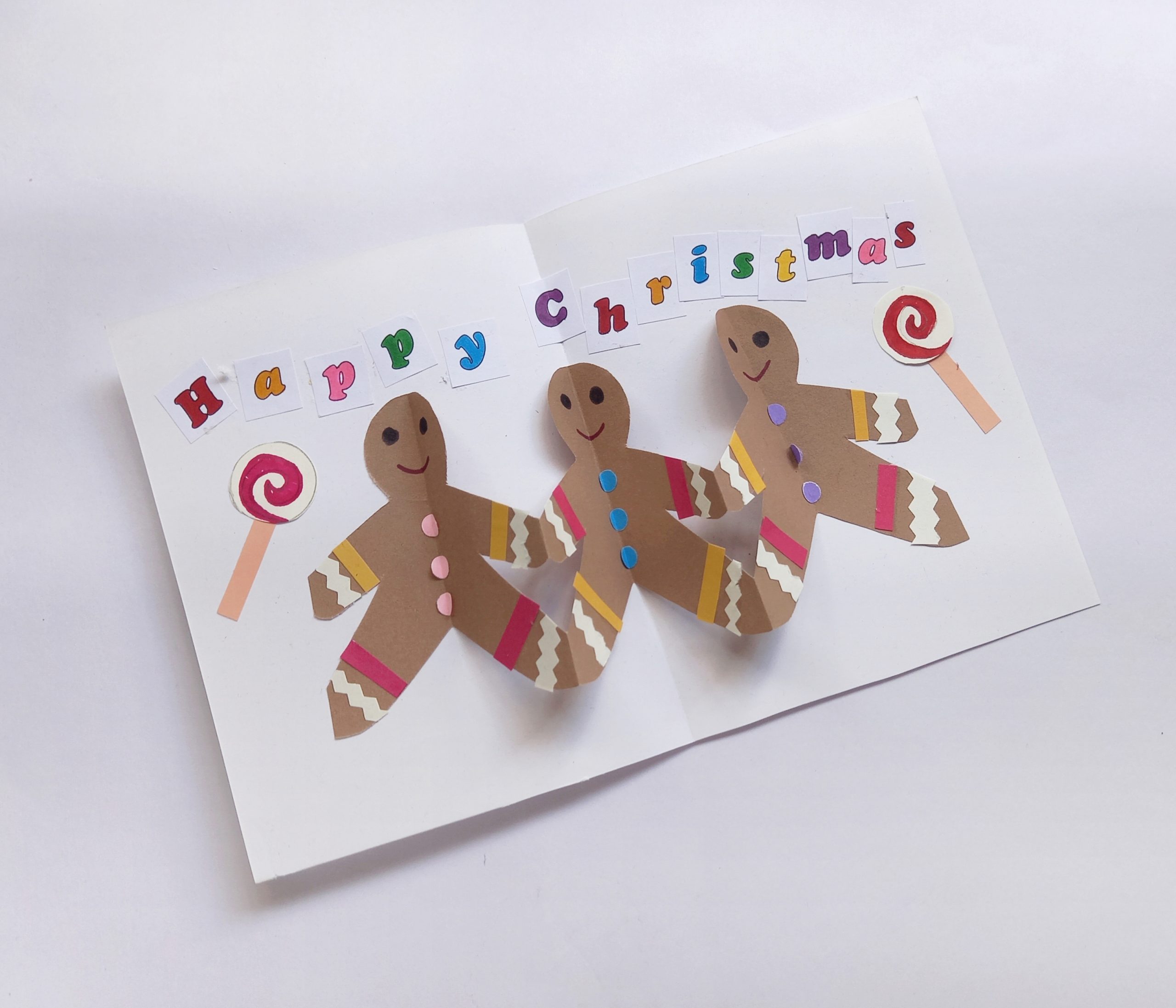 happy christmas pop up card with gingergbread men